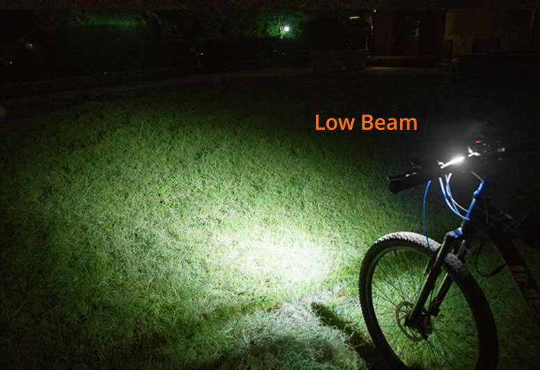 ØM3 bike lamp mounted on handlebar with low beam